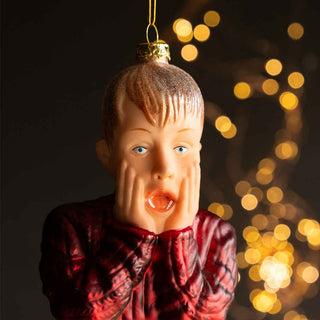 A bauble inspired by the character 'Kevin' from the movie Home Alone - Kevin is holding his face and yelling, having just splashed on some of his dad's aftershave