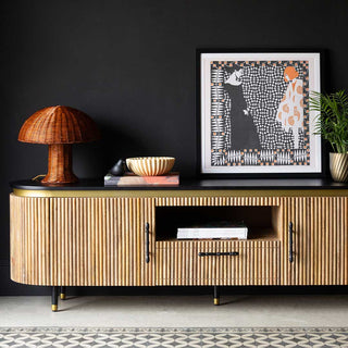 a beautiful ribbed tv unit styled with bamboo lighting, rust artwork and autumn accessories.