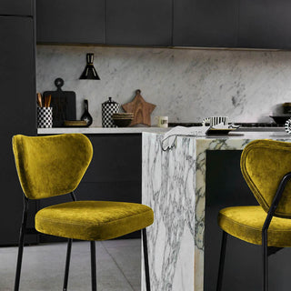 green velvet bar stools against a charcoal kitchen with white marble