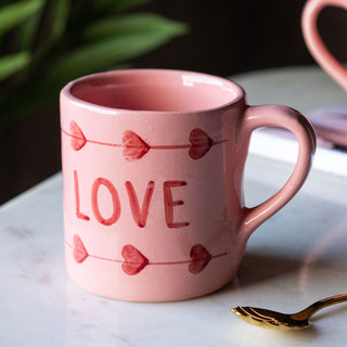 Beautiful hand-painted pink mug with red letters that say 'Love'.