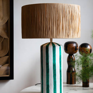 Green stripe lamp with a straw shade.