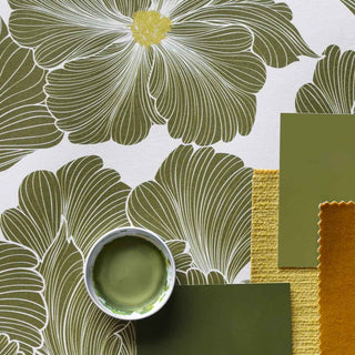 A mood board showing a green floral wallpaper, a green paint swatch and yellow and rust fabric swatches