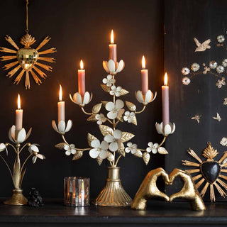 image of wedding gift ideas, including gold love heart objects and flower candelabras against a black background