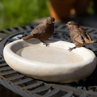 The Love Birds Bowl displayed on a garden table.