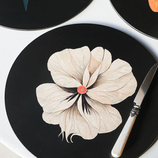 One of the Set Of 4 Beautiful Floral Placemats displayed on a white table with a butter knife.