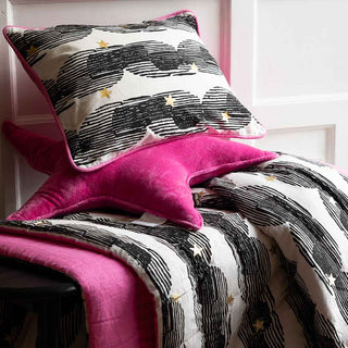 A black and pink cushion on a bench