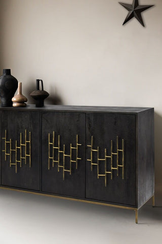 Black mango wood sideboard with antiqued-style brass effect handles, styled with ornaments 