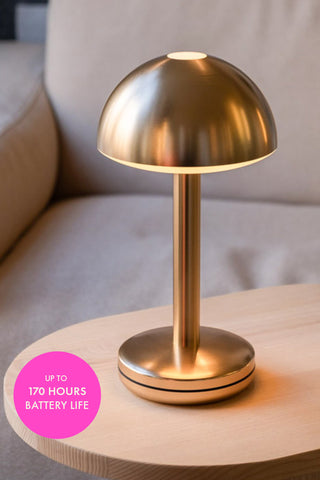 The Humble - Domed Cable-Free Mood Lighting Lighting in Gold on a coffee table.