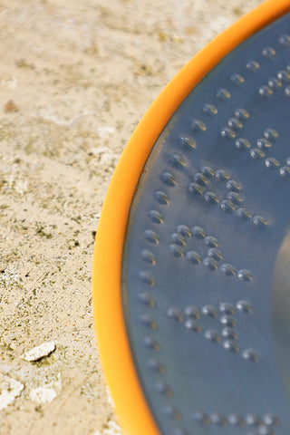 Detail shot of the edge of the Metal & Orange Rim Bon Appetit Dinner Plate.