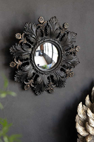 Small black flowers leaves convex mirror.