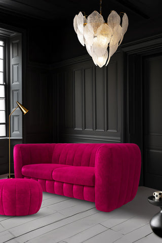 The Bowie Large Sofa In Luxe Kneedlecord Velvet Harry's Pink styled in a dark panelled iving room with a footstool.