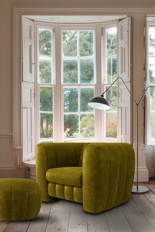 The Bowie Love Seat In Luxe Kneedlecord Velvet Vintage Green styled in front of a bay window