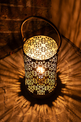 The Rustic-Style Outdoor Lantern illuminated and displayed in a dark corner.