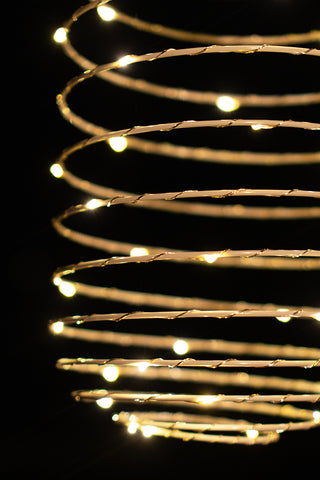 Close-up of the illuminated Spiral Solar Exterior Lamp.