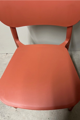 Close up view of seat on orange chair