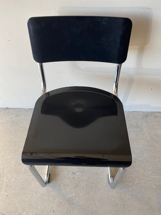 Birds eye view of a black retro chair against a white background