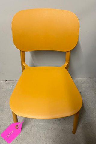 Front facing yellow ochre dining chair in a grey room