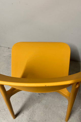 Birds eye view of ochre yellow chair showing damage to back rest