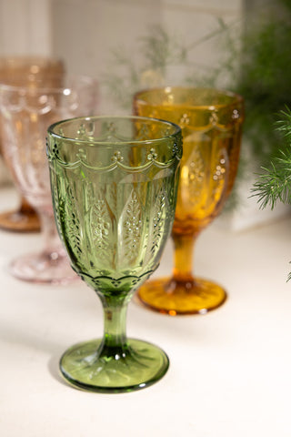 Close-up of one of the Set of 6 Colourful Vintage-Style Wine Glasses, with others in the background.