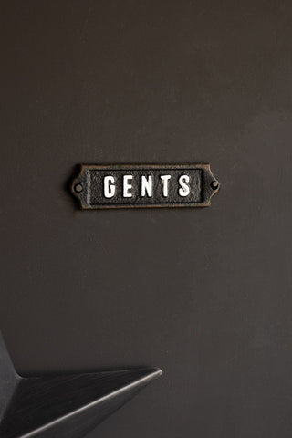 The Gents Door Hanging Sign styled on a black wall with part of a star ornament in the corner of the shot.