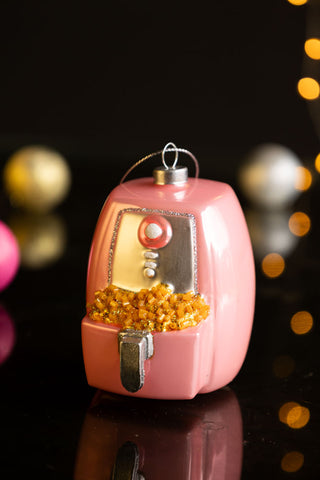 The Air Fryer Christmas Tree Decoration with lights glowing in the background.