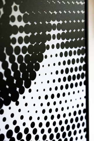 Close-up of a dot design on a canvas.