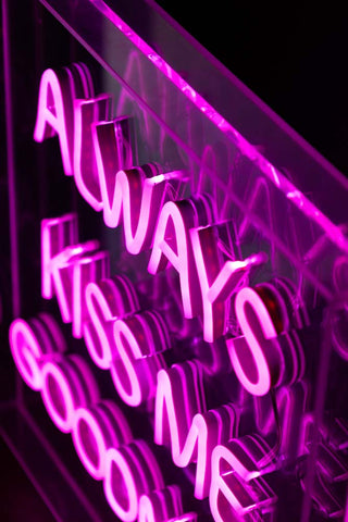 Close-up of the Always Kiss Me Goodnight Neon Light Box switched on and seen from above.