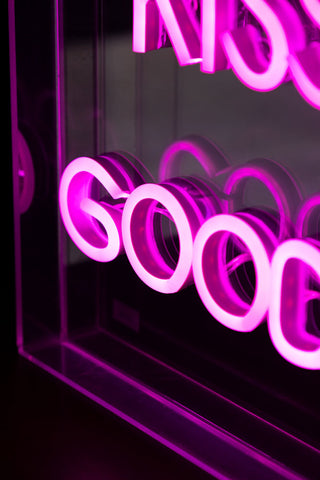 Close-up of the illuminated text of the Always Kiss Me Goodnight Neon Light Box.