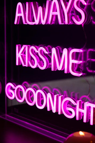 Detail shot of the text of the Always Kiss Me Goodnight Neon Light Box, with the light illuminated.