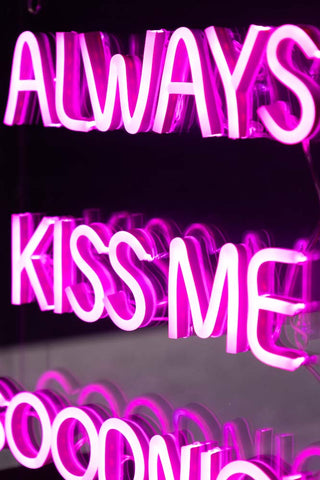 Close-up of the illuminated text of the Always Kiss Me Goodnight Neon Light Box.