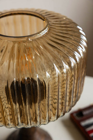 A close-up of a ribbed amber glass lampshade