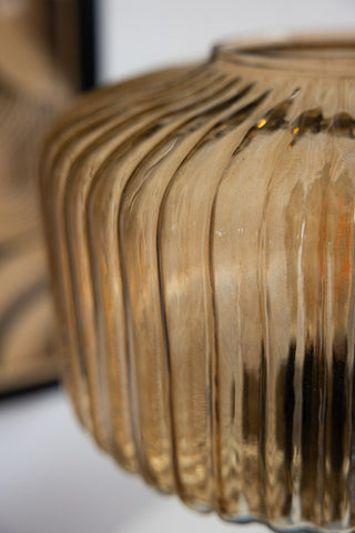 A side-on shot of an amber-coloured ribbed glass lampshade 