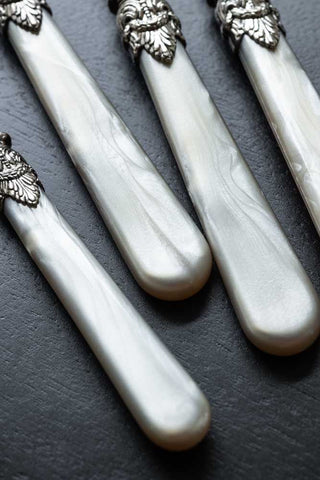 Close-up shot of the handles of the Antique Champagne Cutlery 4-Piece Set.