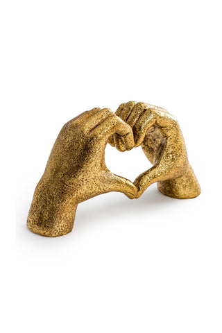 Cutout of the Antique Gold Heart Hands Ornament seen from an angle, on a white background.