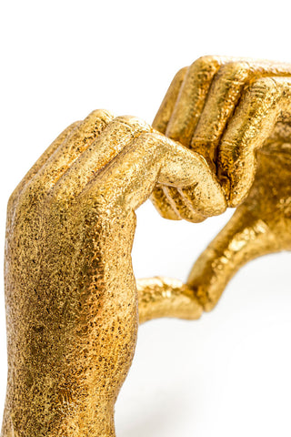 Close-up of the Antique Gold Heart Hands Ornament on a white background.