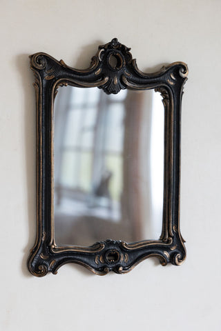 The Antique-Inspired Black Framed Mirror on a neutral wall.