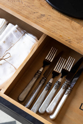 Close-up of the Apothecary Dining Table with the drawer open, with cutlery and napkins styled inside.