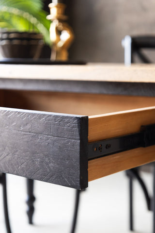 Detail shot of the open drawer of the Apothecary Dining Table.