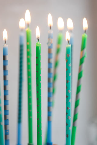 Close-up of the lit Assorted Blue Cake Candles - Pack Of 10.