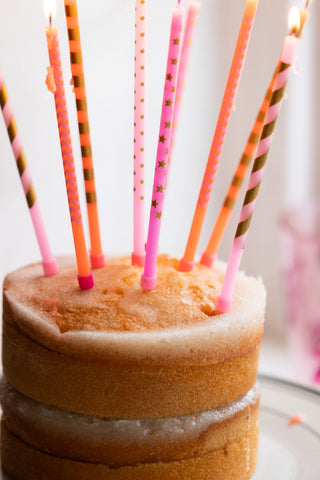 Close-up of the Assorted Pink Cake Candles - Pack Of 10 styled on a cake.