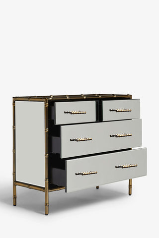 Cutout of the Mirrored Bamboo Effect Chest Of Drawers with the drawers open, seen from a side angle, on a white background.