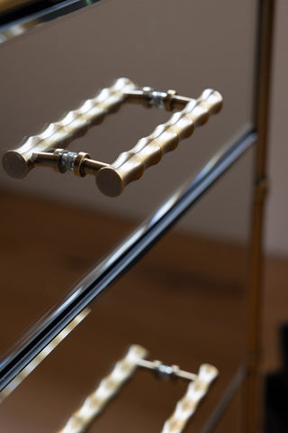 Detail shot of the handles on the Mirrored Bamboo Effect Chest Of Drawers.