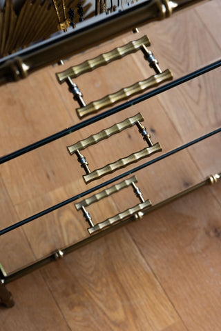 Close-up of the handles on the Mirrored Bamboo Effect Chest Of Drawers, seen from above.