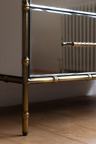 Detail shot of the leg and bottom corner of the Mirrored Bamboo Effect Chest Of Drawers.