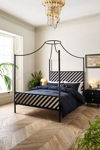 Lifestyle image of the Bamboo Bed styled with navy blue bedding in a bedroom setting.