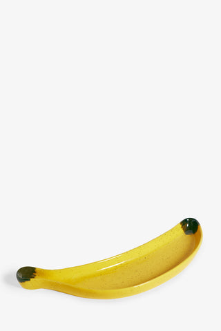 Cutout image of the Banana Serving Plate on a white background, seen at an angled view.