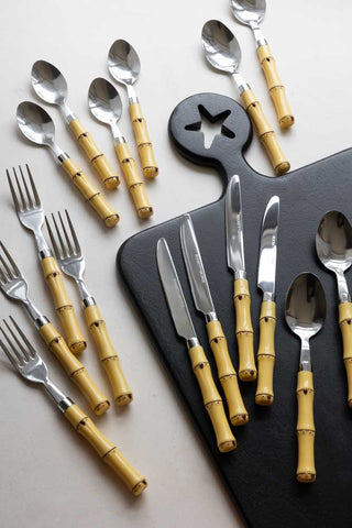The complete Beautiful 16-Piece Bamboo Design Cutlery Set arranged on a black serving board/white surface.