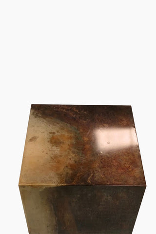 The Beautiful Burnished Metal Side Table seen from above, on a white background.