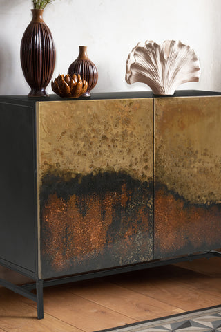 Close-up of the Beautiful Burnished Metal Sideboard, styled with vases and ornaments on top.