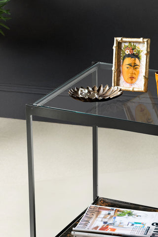 Close-up of the Beautiful Burnished Metal & Glass Side Table styled with various accessories on.